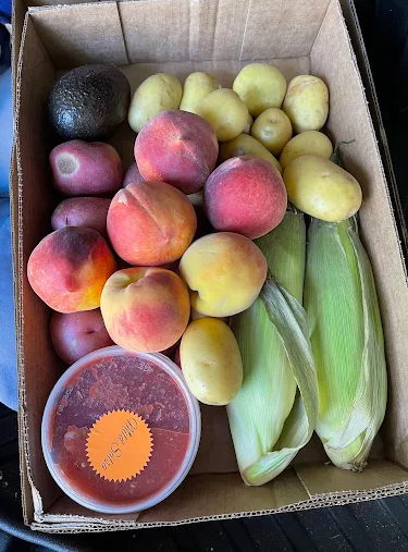 A customer's haul - peaches, corn, salsa and more