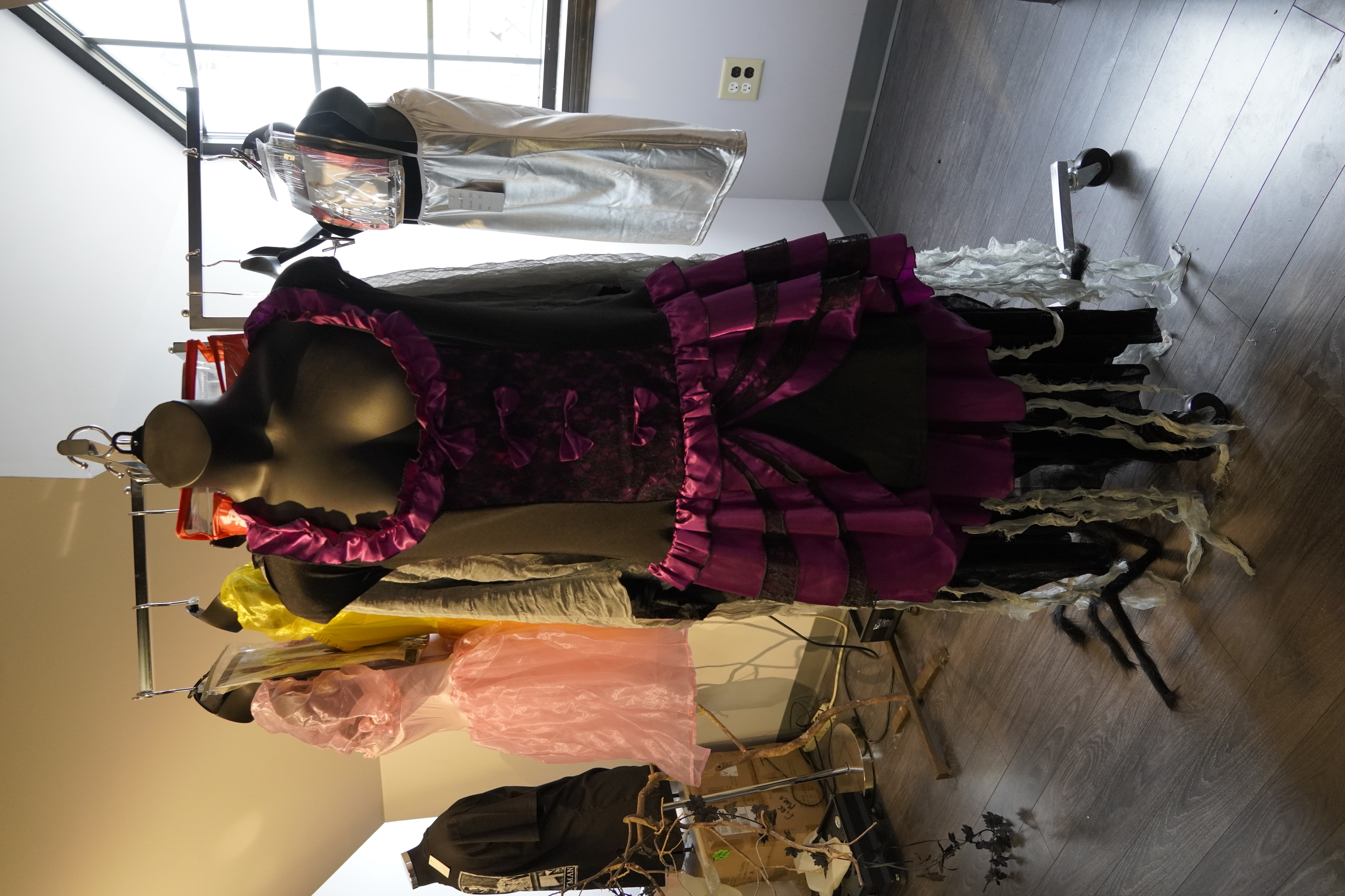 Costume racks packed with year-round Halloween costumes for adults and kids.